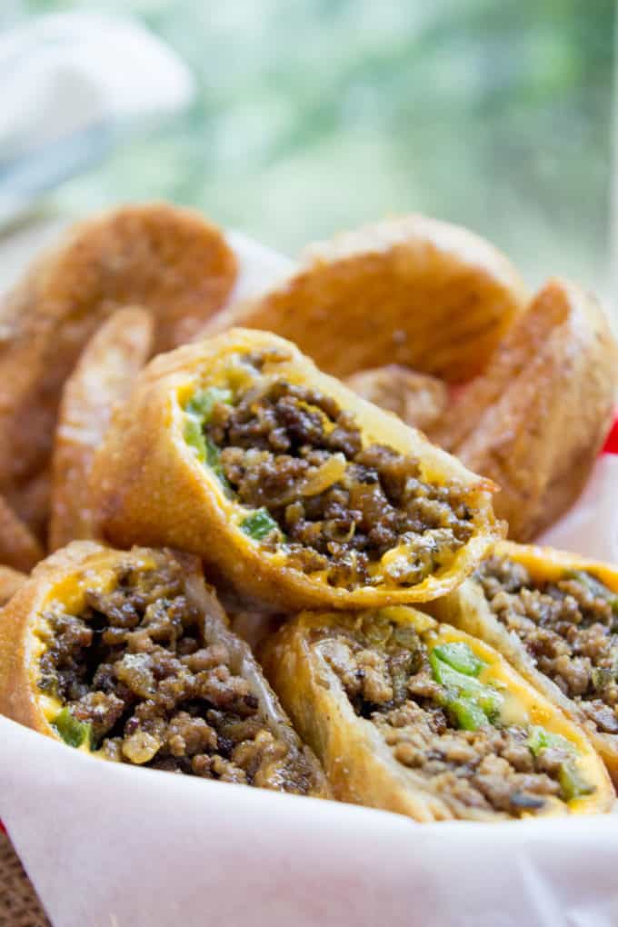Cheesesteak Egg Rolls have all the flavors of the classic Philly Cheese Steak Sandwich in a crispy shell and made with ground beef! So easy to make and they taste...AMAZING.