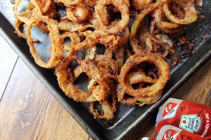 Onion Rings on baking dish with sides of ketchup