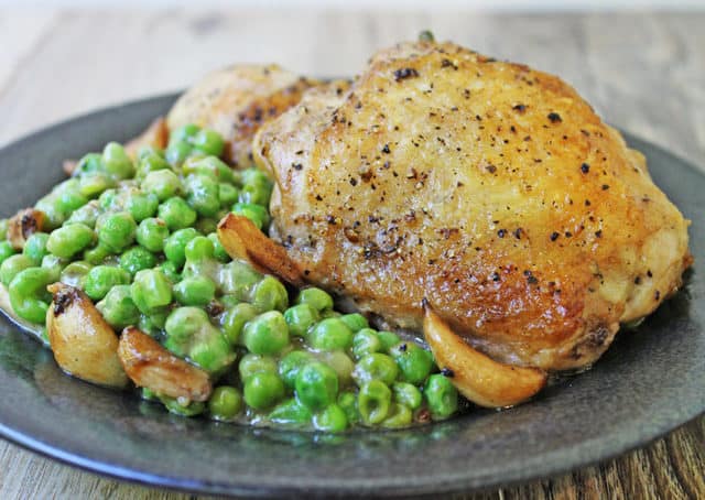 Crispy skinned chicken in a luscious white wine sauce with caramelized garlic and green peas. This is a one pot stove-top meal your family is going to absolutely love!