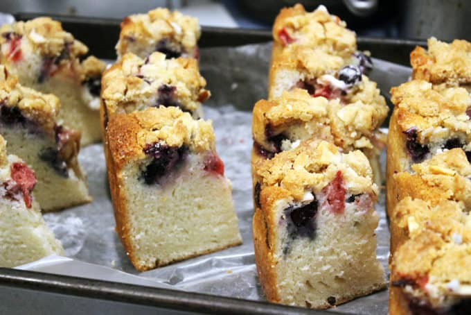 Sweet & Tangy Triple Berry Sour Cream Crumb Cake with Slivered Almonds. A delicious summer treat with the ripest sweetest fruit. The cake is tangy from the sour cream, sweet from the berries and crispy from the topping.