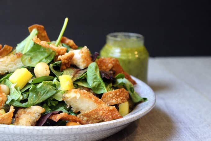 Tropical Macadamia Crusted Chicken on a salad with a Pineapple Jalapeno Vinaigrette and Crispy Wontons. A light summer meal, reminiscent of salads you may eat on a tropical vacation!