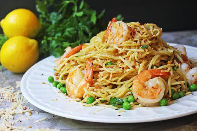 Crispy Shrimp Scampi Pasta with Parmesan & Peas. A deliciously crispy, spicy, cheesy and buttery shrimp pasta dish that elevates a shrimp scampi to a higher level with buttery crispy crackers instead of a panko crust. Perfect with a glass of white wine and a light salad.