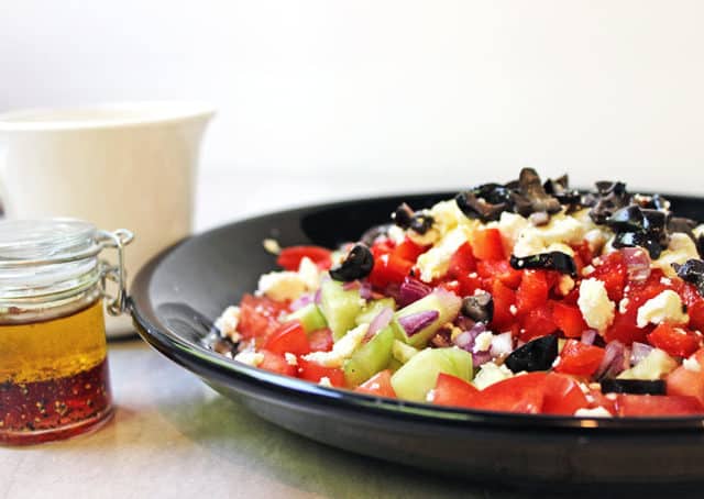 A delicious Rainbow Greek Vegetable salad in a rainbow of colors. Fresh and healthy it is topped with salty rich feta and kalamata olives. Less than 200 calories a serving, eat the rainbow!