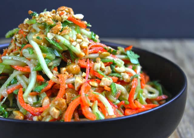 A fresh, crunchy Asian Lime-Peanut Slaw with fresh cucumbers, carrots and bell peppers. Seasoned with sesame oil, lime juice and peanut butter this dish will make your friends and family think you're a rockstar in the kitchen!