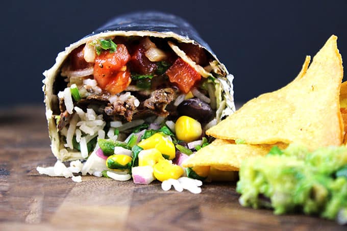 Spicy, seasoned beef cooked low and slow to tender perfection! Your favorite Mexican take out! You'll love this amazingly easy copycat version of the famous Chipotle Barbacoa Beef Burrito so you can feed a large crowd and save 80% the price!