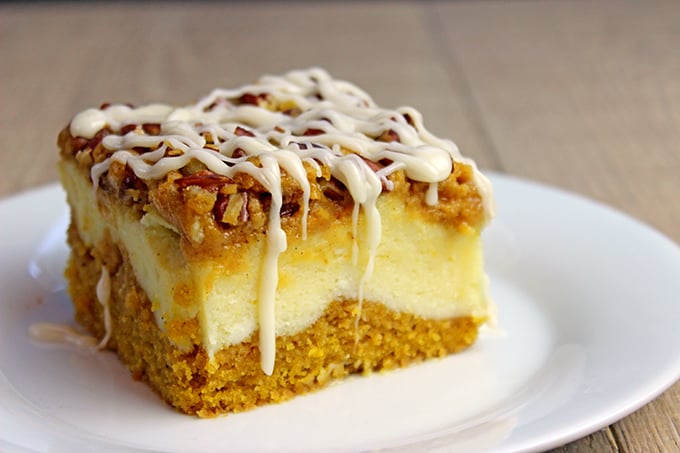 Delicious pumpkin bread with a layer of sweet cheesecake topped with crunchy pecans. Everything you could want in a Fall themed dessert and more. It's easy enough to remember the four ingredients and it works for when you don't need that super thick, rich cheesecake. The addition of the chopped pecans adds a crunchy element to the soft cake, and creamy cheesecake and icing layers. 
