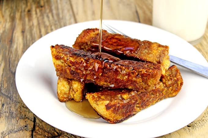 Brûléed Pumpkin French Toast Sticks on plate with maple syrup
