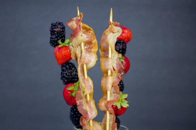 Bacon is threaded onto a soaked bamboo skewer and baked perfectly crisp in the oven while a mixed berry kabob is lightly flavored with a hint of sweetness, lemon and mint. Your brunch guests will LOVE these skewers.