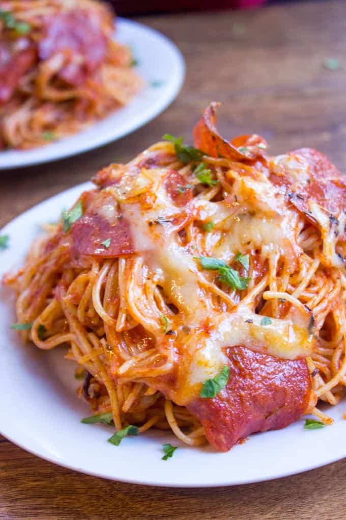 A mix of pepperoni pizza and cheesy marinara pasta, this Easy Baked Pepperoni Pizza Spaghetti is a fun alternative to pizza night and perfect for a crowd! dev.dinnerthendessert.com