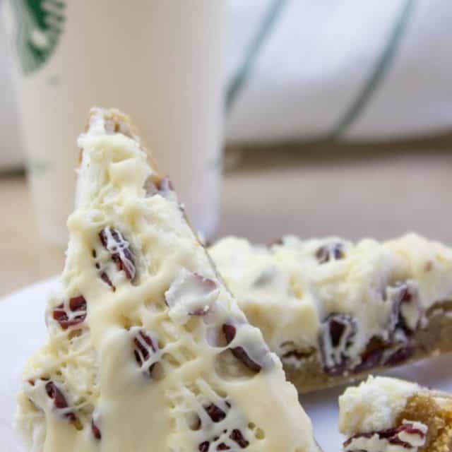 Starbucks White Chocolate Cranberry Bliss Bars are a delicious blondie cookie bar with white chocolate topped with sweet cream cheese icing, tart dried cranberries, and a sweet white chocolate orange drizzle.