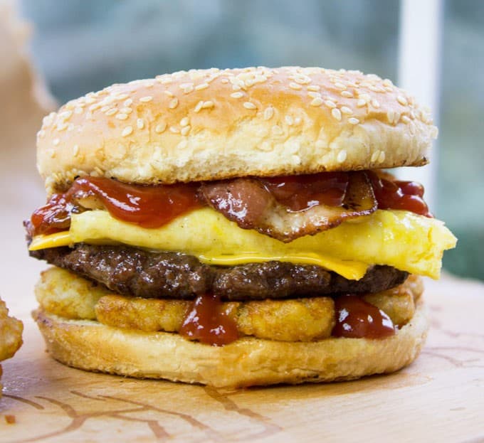 Carl's Jr. Breakfast Burger with seared beef patty, crispy hash browns, scrambled eggs, cheese and glorious bacon. All the flavor, no drive through.