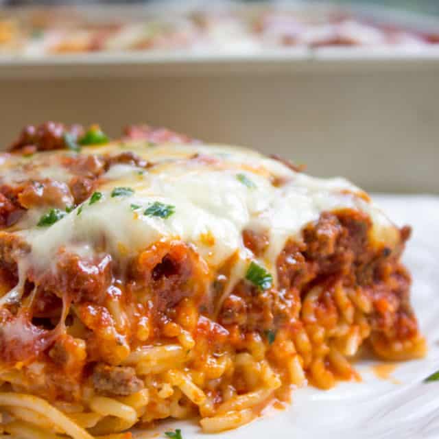 Baked Million Dollar Spaghetti is creamy with a melty cheese center, topped with meat sauce and extra bubbly cheese. Tastes like a cross between baked ziti and lasagna with half the effort!