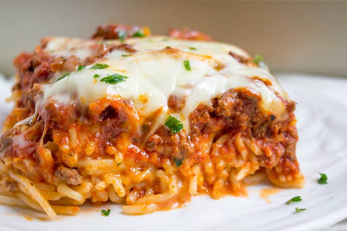 Baked Million Dollar Spaghetti is creamy with a melty cheese center, topped with meat sauce and extra bubbly cheese. Tastes like a cross between baked ziti and lasagna with half the effort!