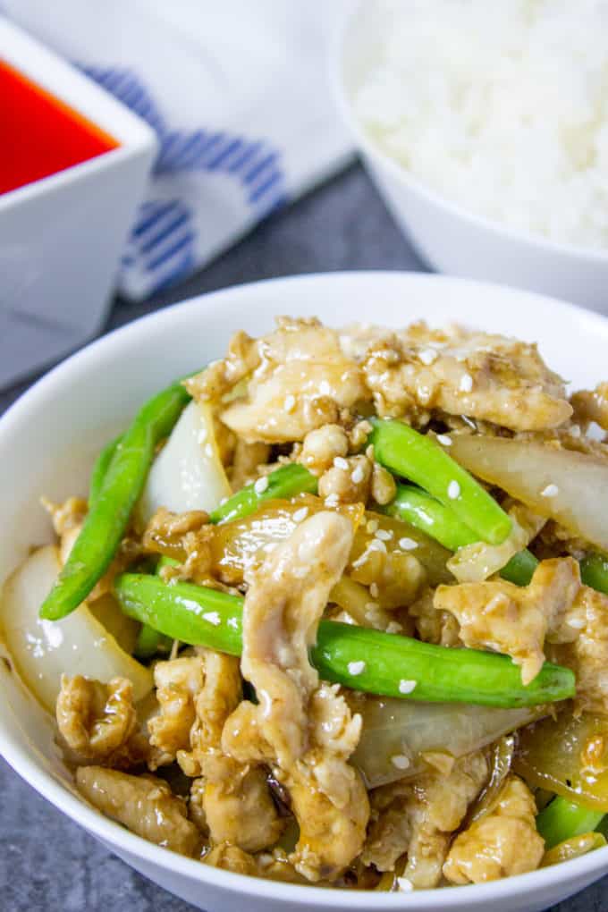 Panda Express String Bean Chicken Breast with onions cooked quickly in a wok in a light ginger soy sauce.