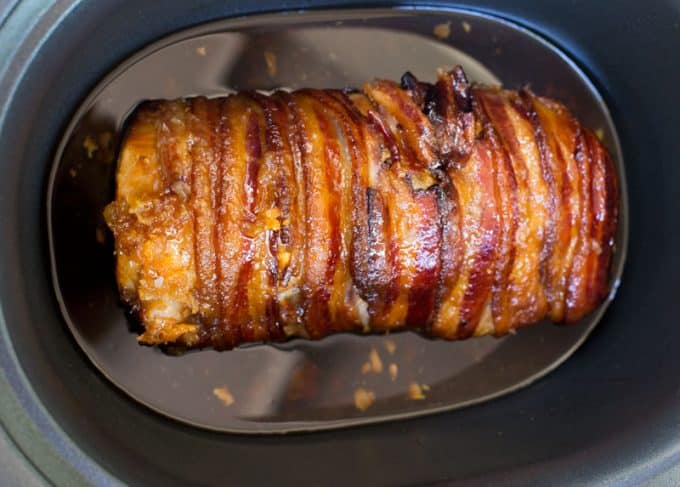 perfectly cooked crock pot pork loin with garlic and bacon
