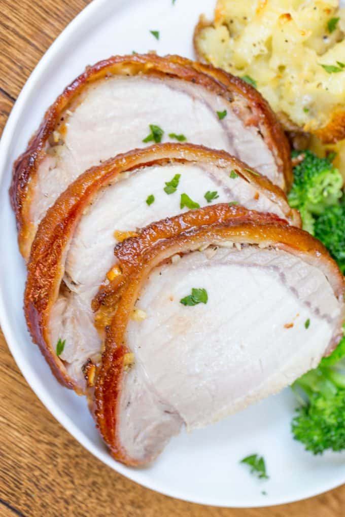 crock pot pork loin wrapped in bacon served with broccoli and potatoes