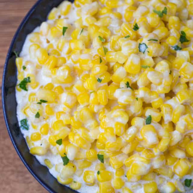 Slow Cooker Creamed Corn is super creamy, made with just a few ingredients and it won't take up any oven space or active cooking time when you're busy preparing for the holidays!