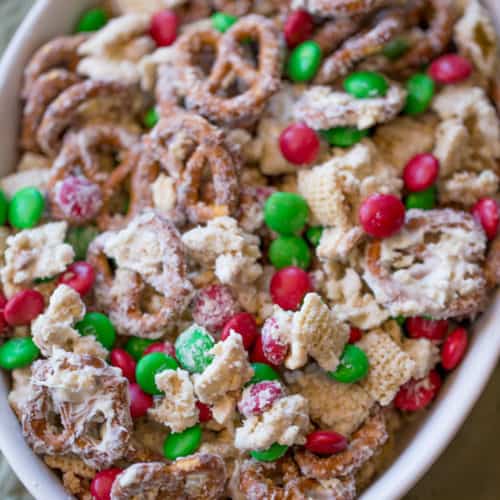 Christmas White Chocolate Trash Snack Mix with pretzels, cereal, peanuts and chocolate coated candies all tossed together with a generous coating of white chocolate.