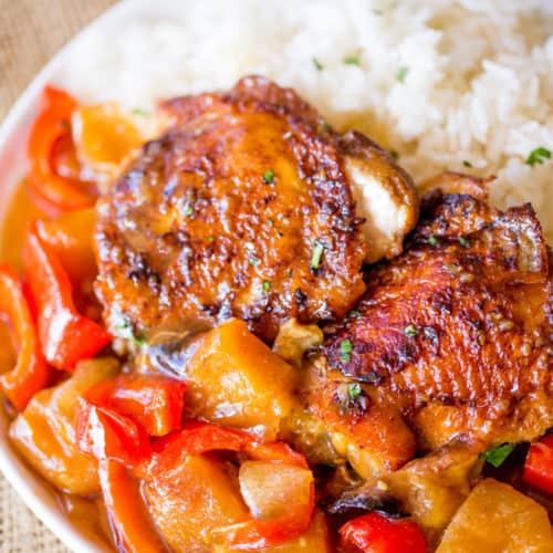 Slow Cooker Hawaiian Pineapple Chicken with crispy chicken thighs, fresh pineapple chunks, onions and bell pepper takes 15 minutes of prep and makes the perfect meal to come home to after a long workday!