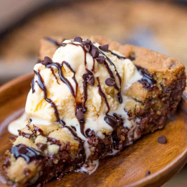 A Chocolate Caramel Pizookie with a dash of sea salt is a delicious giant deep dish cookie pizza just asking to be covered in ice cream and melted chocolate much to the delight of your loved ones!