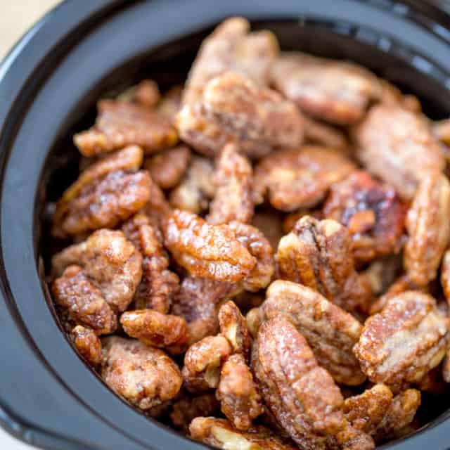 Slow Cooker Candied Cinnamon Pecans are a total breeze to make and will leave your house smelling absolutely delicious! Plus they double as amazing holiday gifts you can make in bulk!