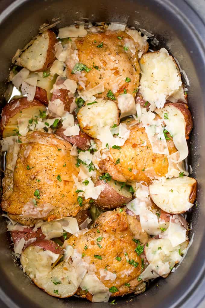Slow Cooker Garlic Parmesan Chicken and Potatoes takes just a few minutes of prep and five ingredients. Crisp chicken thighs, buttery red potatoes and shaved Parmesan cheese make the perfect easy weeknight meal. 