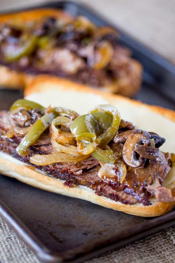 Slow Cooker Philly Cheese Steak Sandwiches that are so tender and flavorful you'll feel like you're in Philly. Perfect for a crowd!