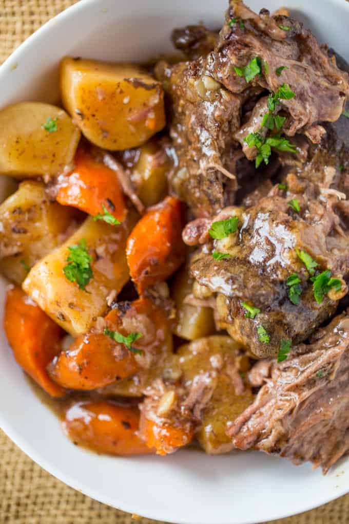 Ultimate Slow Cooker Pot Roast that leaves you with tender meat, vegetables and a built in gravy to enjoy them all with in just 15 minutes of prep! Perfect weeknight dinner!
