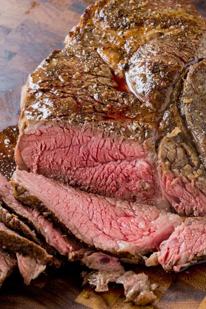 Slow Cooker Roast Beef that you can slice into tender slices cooked to a perfect medium temperature. Enjoy for dinner or sliced thinly in sandwiches, you will never buy the deli variety again!