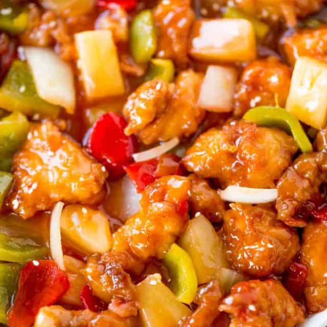 Sweet and Sour Chicken with crispy chicken, pineapple and bell peppers that tastes just like your favorite takeout place without the food coloring.