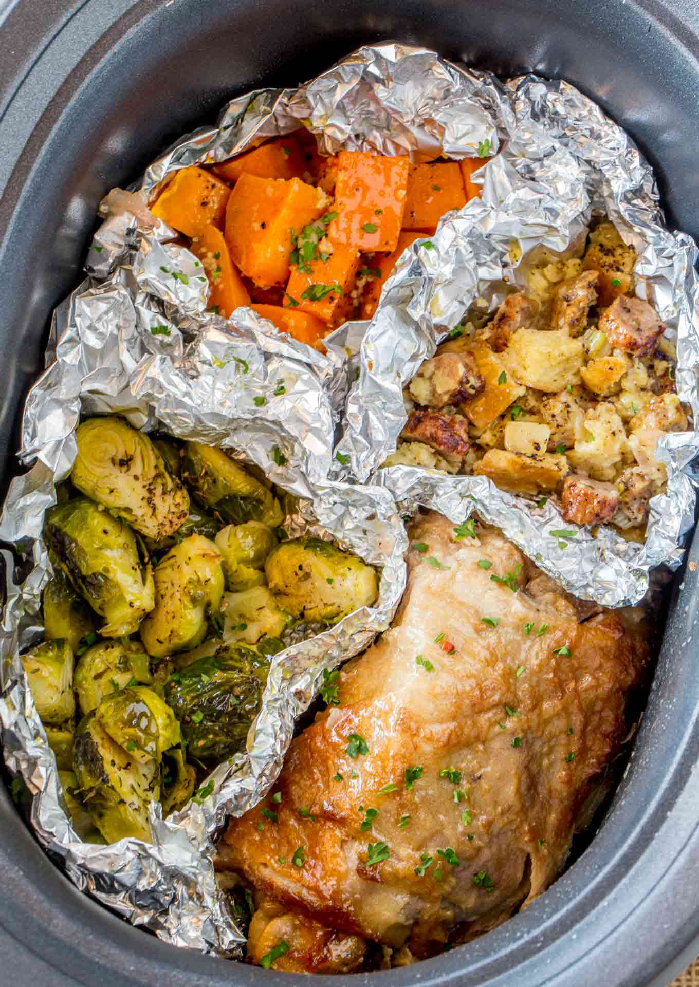 Slow Cooker Thanksgiving Dinner with turkey, sweet potatoes, sausage stuffing and Brussels Sprouts cooked entirely in your Slow Cooker!