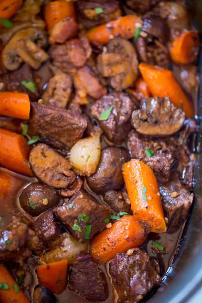The EASIEST Slow Cooker Beef Bourguignon with beef, red wine, mushrooms and bacon made in your slow cooker.