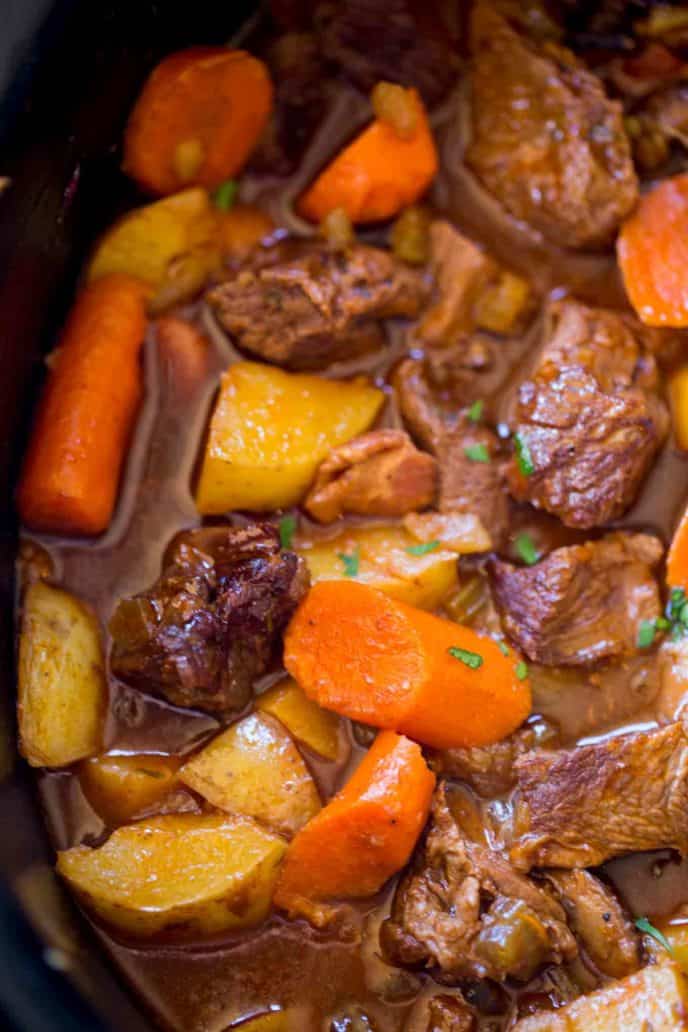 Slow Cooker Guinness Beef Stew with creamy Yukon potatoes, bacon, carrots and a rich tomato beef gravy, this is the perfect winter stew!