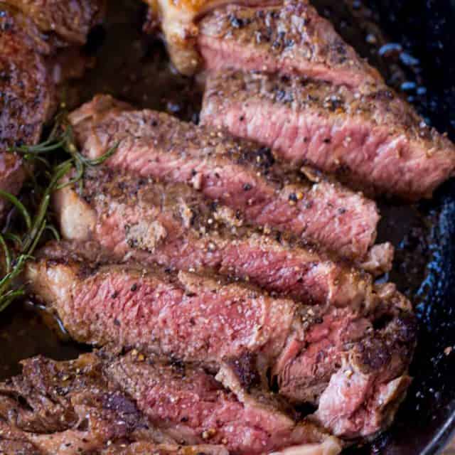 Perfect, Easy Ribeye Steak that is butter basted in a cast iron skillet in the oven with Rosemary. A Perfect error-proof medium rare in 20 minutes.