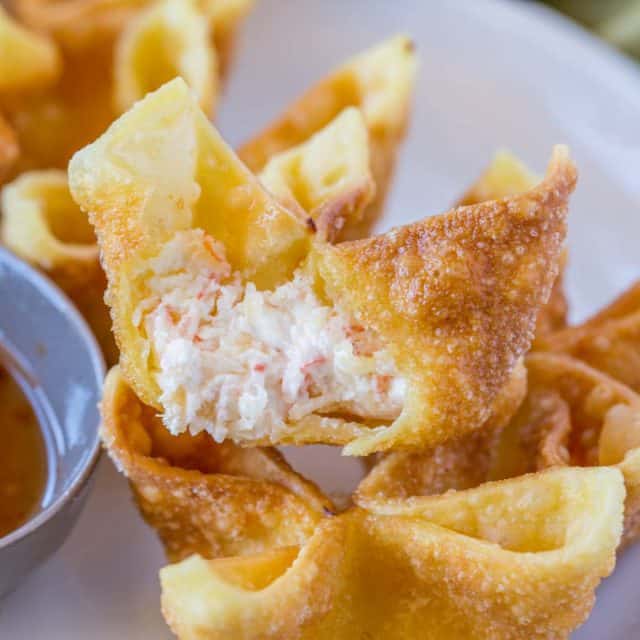Crab Rangoon are crab and cream cheese wontons with green onions pinched into little purses and deep fried, these are the perfect Chinese restaurant copycat recipe served with sweet and sour sauce or sweet chili sauce. | #chinesefood #chinese #copycatrecipe #chinesetakeout #wontons #creamcheese #creamcheesewonton #crabwonton #sweetandsoursauce #easyrecipes #easychinesefood #dinnerthendessert #friedappetizers #appetizer #asianfood #japanesefood #thaifood