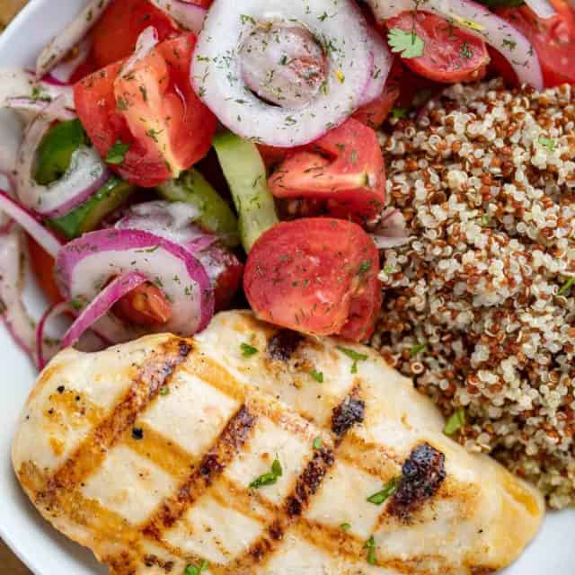 Grilled Chicken with Cucumber Tomato Salad and Quinoa in bowl