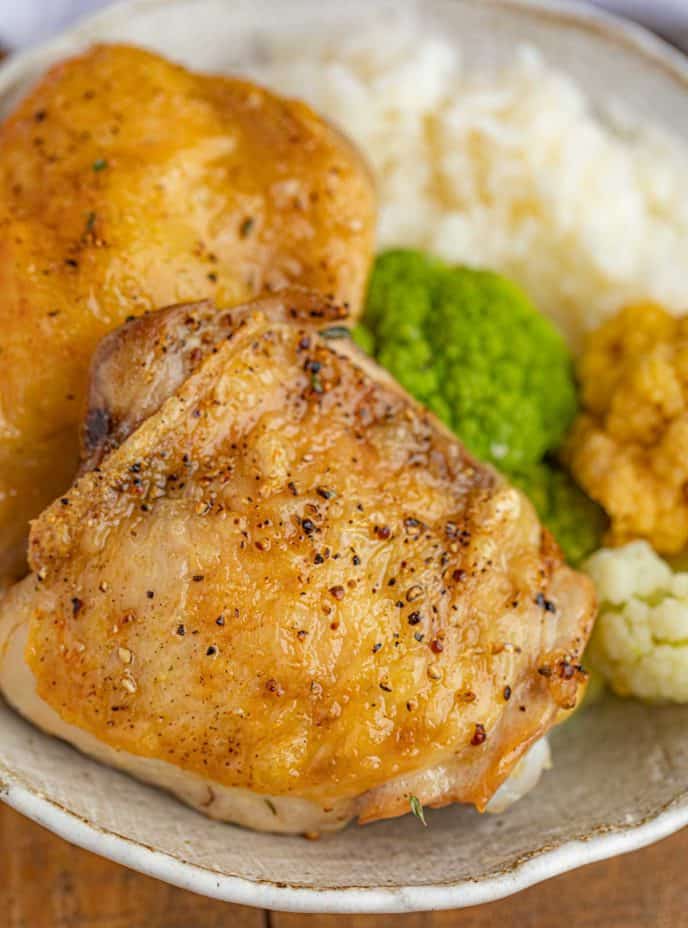 Baked Chicken Thighs in bowl with rice and broccoli
