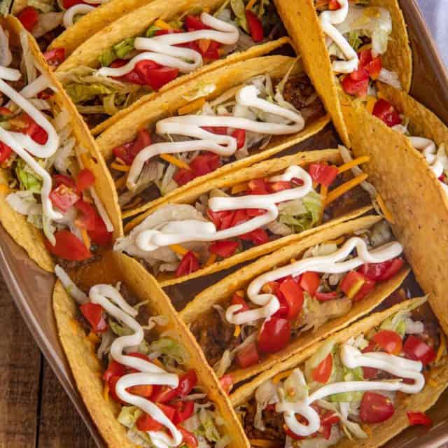 Baked Beef Tacos with toppings in baking dish