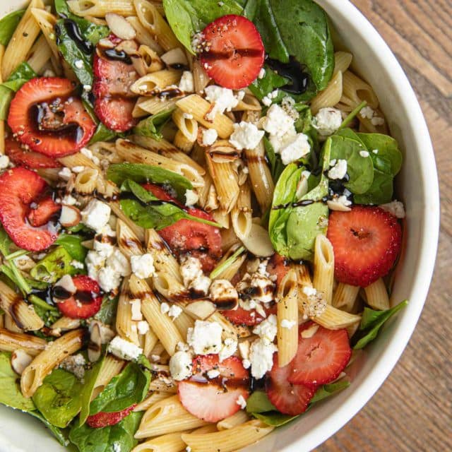 Spinach Pasta Salad with Strawberries in white bowl