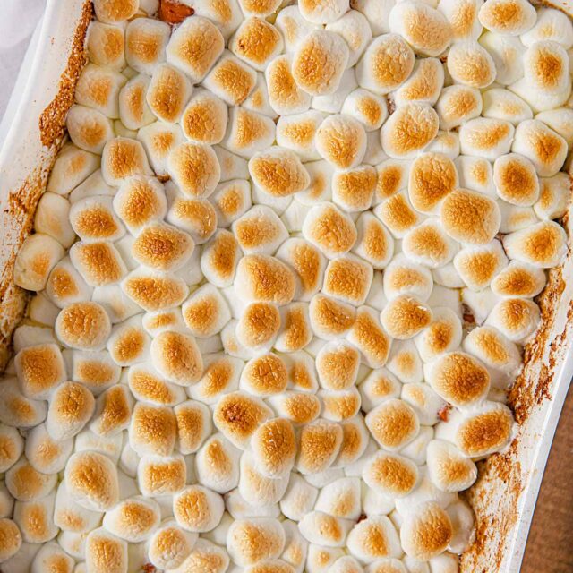 Candied Sweet Potatoes in baking dish topped with toasted marshmallows