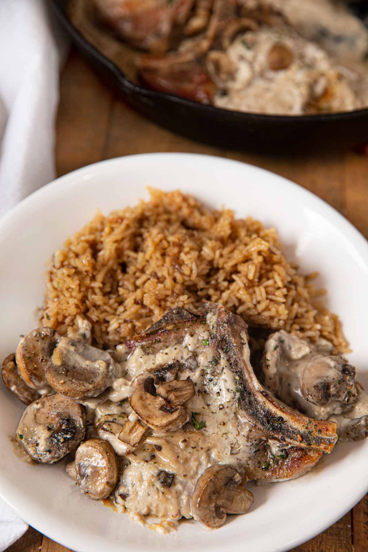 Mushroom Pork with Stick of Butter Rice in white Bowl