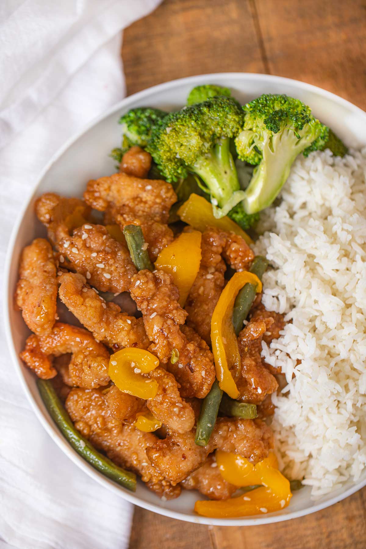 Honey Sesame Chicken Breast from Panda Express with steamed rice and broccoli in white bowl